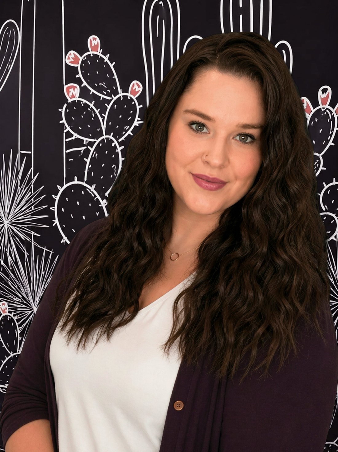 Ashley Landis in front of a hand-drawn Arizona cactus mural